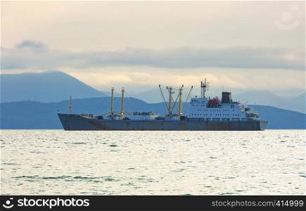 The fishing boat in gray morning on Pacific ocean off the coast of the Kamchatka Peninsula