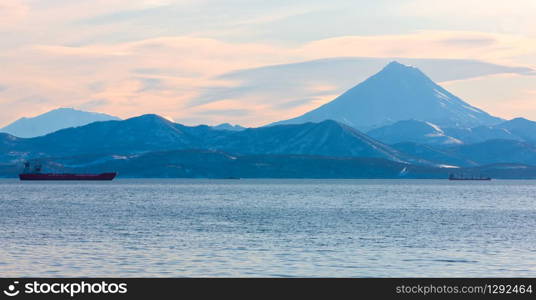 The fishing boats in the Bay with the volcano on Kamchatka. fishing boats in the Bay with the volcano on Kamchatka
