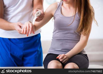 The fitness instructor helping woman during exercise. Fitness instructor helping woman during exercise