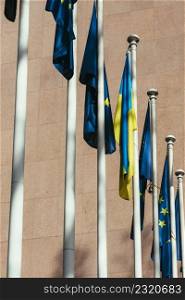 The flag of the European Union and Ukraine flutter in the wind. European Union solidarity concept as Russia invaded Ukraine in February 2022. The flag of the European Union and Ukraine flutter in the wind