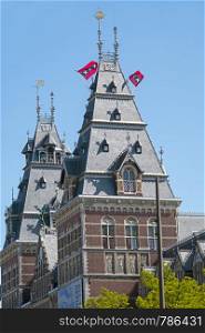 The flags from Amsterdam in the Netherlands on the towers of the Rijksmuseum in Amsterdam the Netherlands