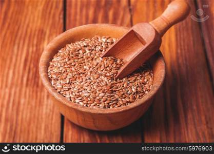 The flax seeds in a wooden bowl close up. flax seeds