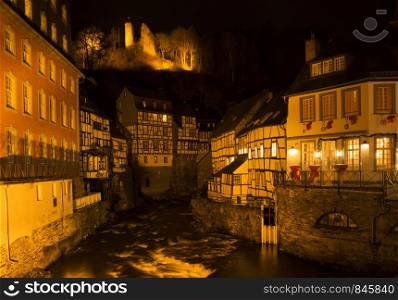 The flood-lit decorated town Monschau in Germany in the Eiffel region. Monschau by night
