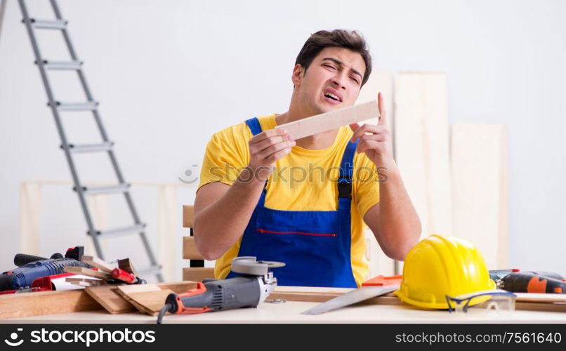 The floor repairman disappointed with his work. Floor repairman disappointed with his work