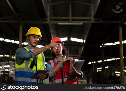 The foreign chief engineer came to inspect the old mechanical factory. There is an African female mechanic explaining details and progress reports on old machines being repaired to restore normal operation.