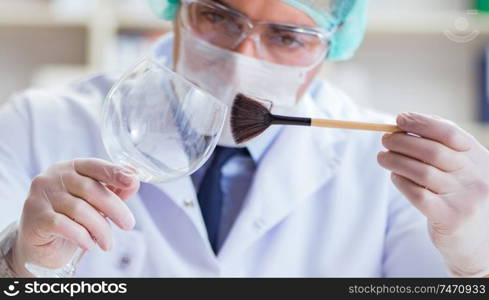 The forensics investigator working in lab on crime evidence. Forensics investigator working in lab on crime evidence