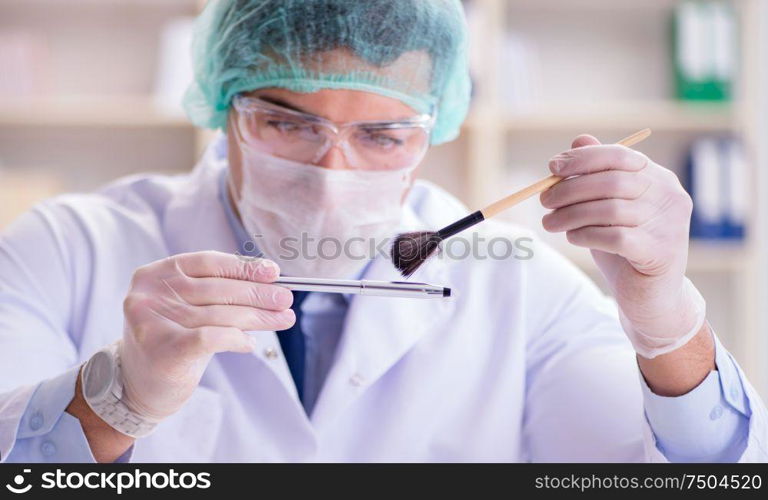 The forensics investigator working in lab on crime evidence. Forensics investigator working in lab on crime evidence