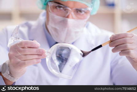 The forensics investigator working in lab on crime evidence. Forensics investigator working in lab on crime evidence