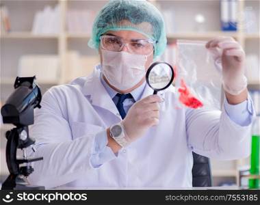 The forensics investigator working in lab on crime evidence. Forensics investigator working in lab on crime evidence