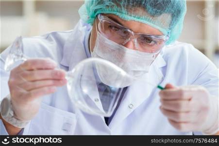 The forensics investigator working in lab on crime evidence. Forensics investigator working in lab on crime evidence