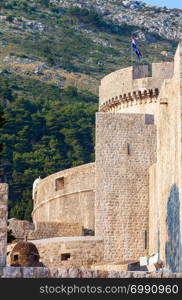 The fortress of Dubrovnik Old Town and the Minceta Tower with Croatian national flag.