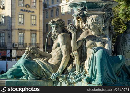 the Fountain with Mermaid Statues of the Rossia Square in Baixa in the City of Lisbon in Portugal. Portugal, Lisbon, October, 2021