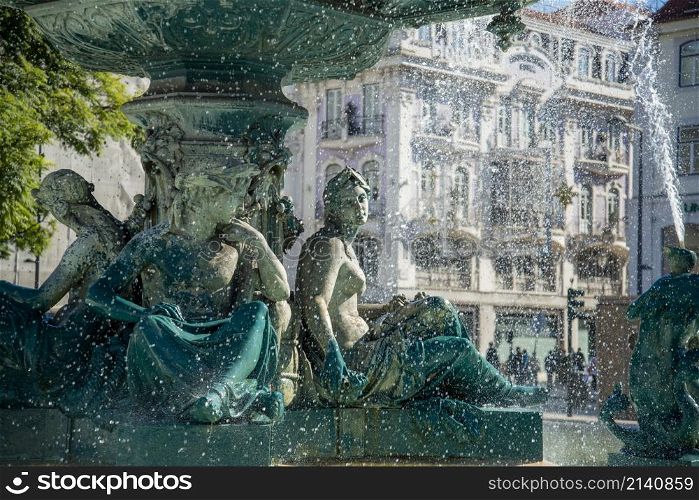 the Fountain with Mermaid Statues of the Rossia Square in Baixa in the City of Lisbon in Portugal. Portugal, Lisbon, October, 2021