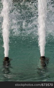 The fountains gushing sparkling water in a pool in a park