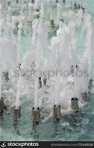 The fountains gushing sparkling water in a pool in a park