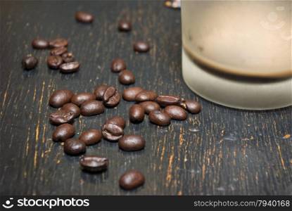 The fragrant fried coffee beans grunge background. Coffee on grunge wooden background