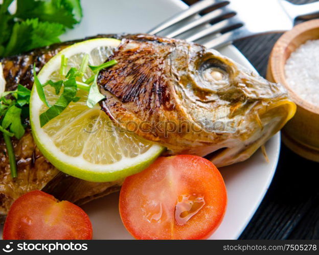 The fried fish served on the plate. Fried fish served on the plate