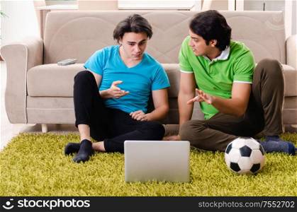 The friends watching football at home. Friends watching football at home