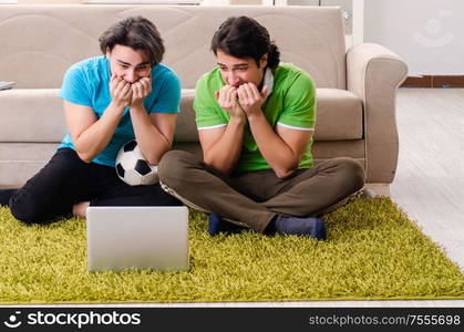 The friends watching football at home. Friends watching football at home