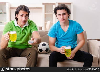 The friends watching football at home. Friends watching football at home