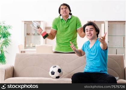 The friends watching football at home. Friends watching football at home