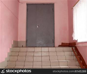 The front metal door with stairs.