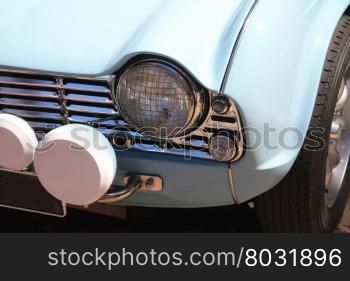 the front of a classic blue car in detail