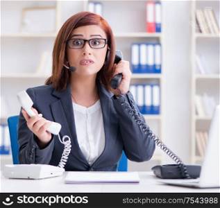 The frustrated call center assistant responding to calls. Frustrated call center assistant responding to calls