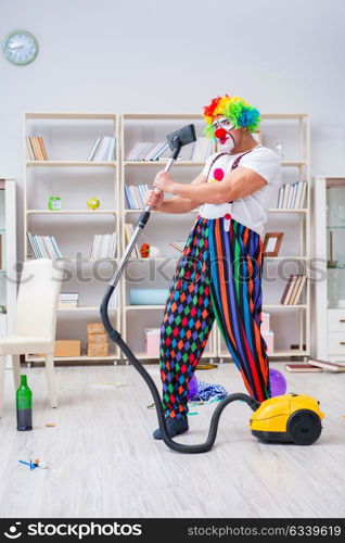 The funny clown doing cleaning at home. Funny clown doing cleaning at home