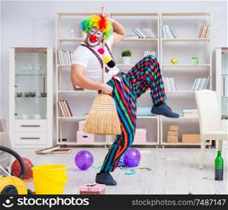 The funny clown doing cleaning at home. Funny clown doing cleaning at home