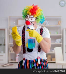 The funny clown doing cleaning at home. Funny clown doing cleaning at home