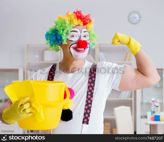 The funny clown doing cleaning at home. Funny clown doing cleaning at home