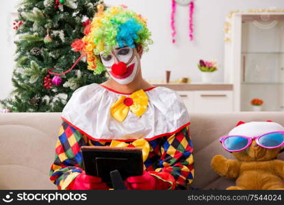 The funny clown in christmas celebration concept. Funny clown in Christmas celebration concept