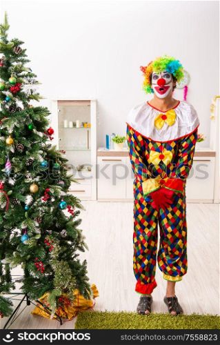 The funny clown in christmas celebration concept. Funny clown in Christmas celebration concept
