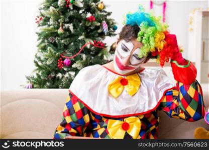 The funny clown in christmas celebration concept. Funny clown in Christmas celebration concept