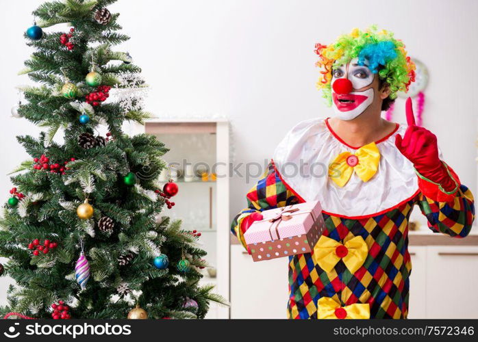 The funny clown in christmas celebration concept. Funny clown in Christmas celebration concept