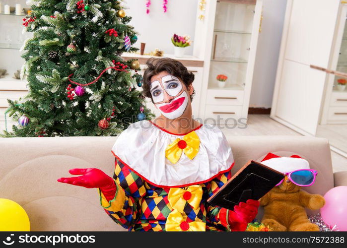 The funny clown in christmas celebration concept. Funny clown in Christmas celebration concept