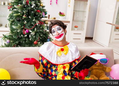 The funny clown in christmas celebration concept. Funny clown in Christmas celebration concept