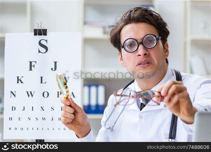 The funny eye doctor in humourous medical concept. Funny eye doctor in humourous medical concept