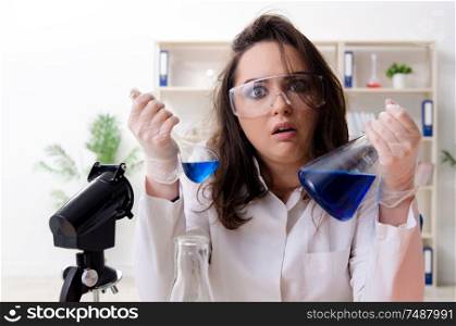 The funny female chemist working in the lab. Funny female chemist working in the lab