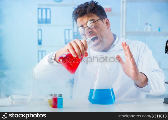 The funny mad chemist working in a laboratory. Funny mad chemist working in a laboratory