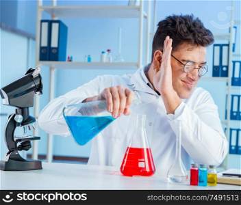 The funny mad chemist working in a laboratory. Funny mad chemist working in a laboratory