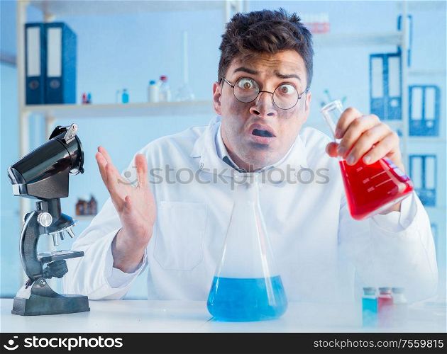 The funny mad chemist working in a laboratory. Funny mad chemist working in a laboratory