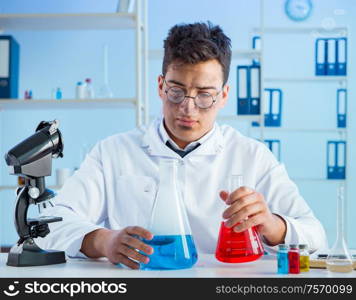 The funny mad chemist working in a laboratory. Funny mad chemist working in a laboratory