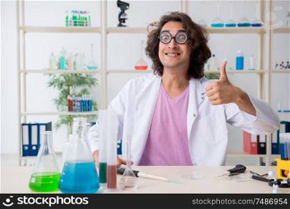 The funny male chemist working in the lab. Funny male chemist working in the lab