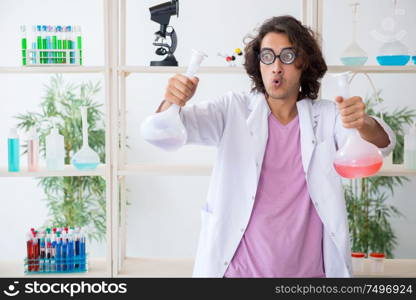 The funny male chemist working in the lab. Funny male chemist working in the lab