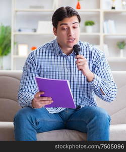 The funny man singing songs in karaoke at home. Funny man singing songs in karaoke at home