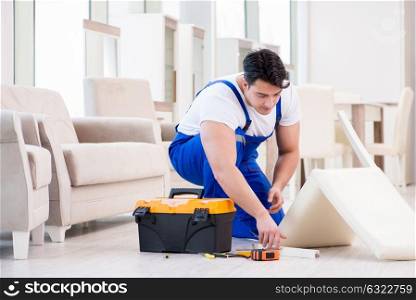 The furniture repairman working in store. Furniture repairman working in store