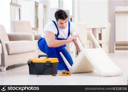 The furniture repairman working in store. Furniture repairman working in store