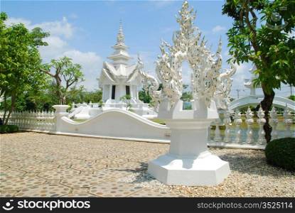 The garden of famous Wat Rong Khun White temple in Thailand.